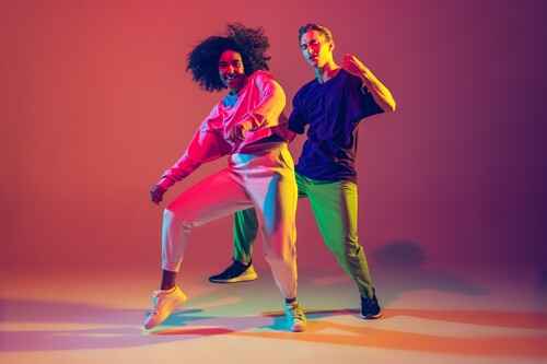 dance-time-stylish-men-woman-dancing-hip-hop-bright-clothes-green-background-dance-hall-neon-light_500x333_1_11zon